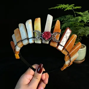 Close-up detail of the natural crystal crown headband with metal moon and red rose decor.
