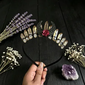 Crystal tiara close-up detail featuring raw quartz clusters, black lace moon and red rose.