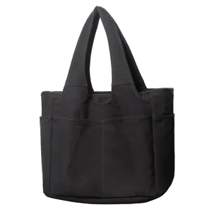 Black canvas tote bag detail view, multi-pocket casual shoulder bag for daily work and travel.