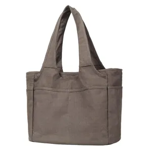 Grey canvas tote bag detail view, casual shoulder handbag with multiple pockets for daily work.