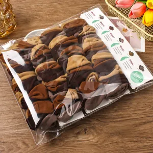 Detailed view of wide brown hair bands set in transparent packaging with card, ideal for daily use.