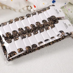 Detail view of knitted seamless hair ties, leopard print hair scrunchies, bulk pack.