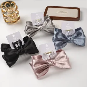 Detailed close-up of sweet bow hair claw clips with card packaging in four elegant colors.
