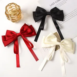 Elegant satin bow hair clip with long drape ribbon for women and girls stylish hair accessories.