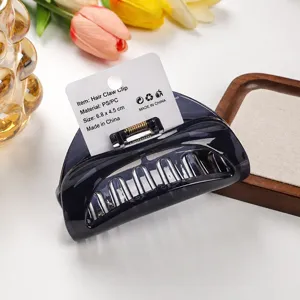 Dark translucent crescent hair claw clip with hanging card, thick sturdy daily hair accessory.