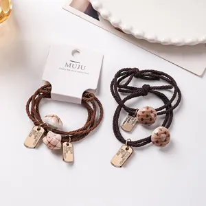 2-pack brown knotted hair ties with charms and card packaging, high elasticity for ponytails.