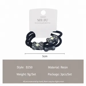Detailed view of the 3-piece resin bow hair ties set with marbled pattern on card display.
