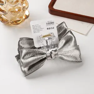 Silver bow hair claw clip detail, elegant fabric hair accessory for women and girls daily styling.