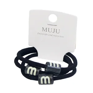 Premium set of 3 black elastic hair ties with marble pattern beads on a display card for women.