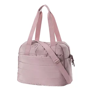 Pink quilted travel bag detail, showing soft padded texture, sturdy handles and strap.