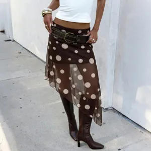 Detail shot of the stylish polka dot mesh asymmetric skirt paired with boots for autumn outfit.