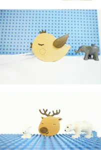 Boîte à musique en bois vue détaillée montrant de mignons oiseaux et cerfs avec des accessoires.