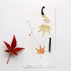 Exquisite metal maple leaf bookmark with decorative backing card, perfect creative stationery gift.