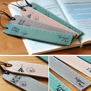 Vintage wooden ruler bookmarks with Paris architecture design and leather cord for reading.