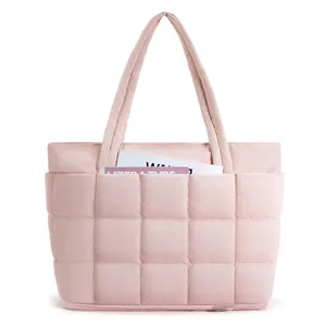 Pink quilted puffer tote bag detail, featuring puffy grid pattern, dual handles and bottom zipper.