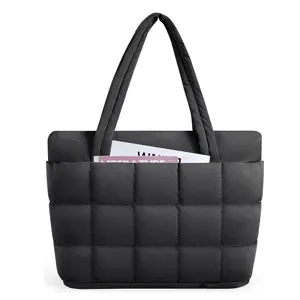 Black quilted tote bag with puffer design, dual top handles, front pocket and expansion zipper.