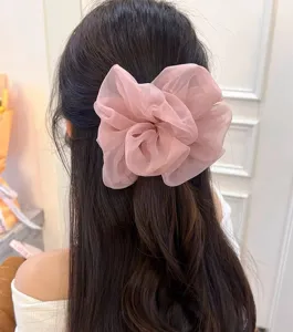 Oversized pink organza hair scrunchie for women, elegant fluffy hair tie and cute bun accessories.