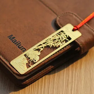 Traditional Chinese style metal bookmark with hollow crane bamboo pattern and red tassel.