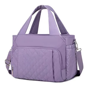 Purple quilted insulated lunch bag detail view, showing soft fabric and metal hardware.