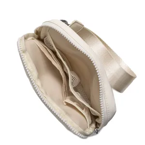 Detailed interior view of a cream nylon waist bag featuring multiple mesh storage pockets.