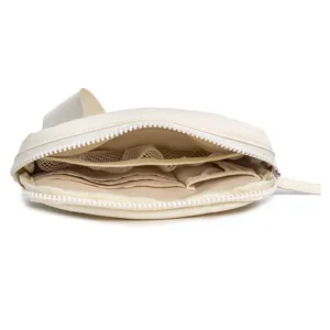 Close-up of open nylon belt bag interior with multiple card slots and mesh zip pockets.