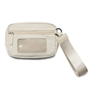 Detailed view of white nylon wristlet wallet featuring clear ID window and secure zip compartment.