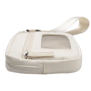 Detail view of the white nylon wristlet wallet showing zipper and clear card window.