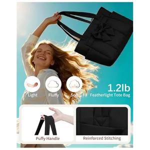 Detail view of lightweight black quilted puffer tote bag with bow, soft handle and spacious interior.