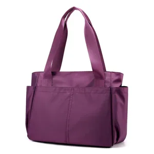 Detail view of purple nylon travel tote bag, lightweight casual shoulder handbag for women.