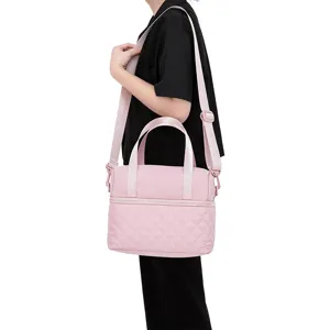 Pink quilted insulated lunch bag for women, stylish crossbody handbag and portable cooler bag.