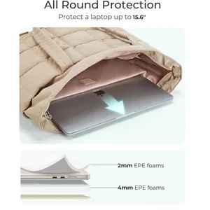 Quilted tote bag detail showcasing 15.6 inch laptop compartment with protective foam layers.