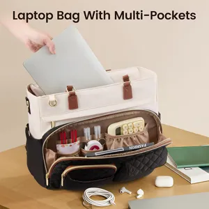 Detailed view of the multi-pocket laptop tote bag showing organized compartments and desk setup.