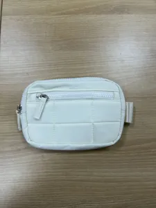 White nylon quilted wallet pouch detail view, featuring compact size and multiple zip pockets for travel.