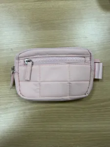 Pink quilted nylon pouch wallet with zipper closure and compact travel card design.