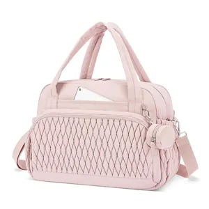 Pink quilted diaper tote bag detail, multi-pocket travel shoulder bag with pacifier case.