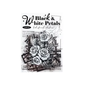 Close-up detail of retro black and white rose line art and film strip journal stickers.