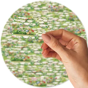 Detail shot showing the stone path floral washi tape sample held neatly by hand for crafts.