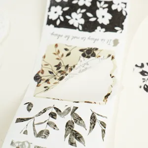 Botanical washi tape detail shot showing floral patterns and a quote design for DIY crafts.