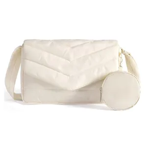 Detailed close-up view of the stylish quilted chevron crossbody bag featuring a handy round pouch.