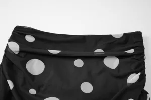 Black mesh polka dot skirt detail showcasing textured fabric and elegant ruching design.