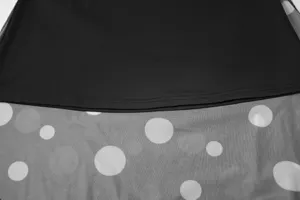 Close-up detail of women skirt mesh polka dot fabric layer, showing delicate stitching.