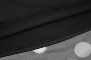 Close-up detail view of women's skirt, featuring black fabric and white polka dot mesh splicing.