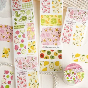 Close-up detail of summer fruit washi tape rolls and aesthetic decorative journal stickers.