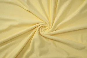 Light yellow fabric material detail close up shot showing soft texture and elegant drape.