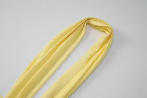 Yellow fabric strap detail shot, soft texture and bright color for women's dress design.