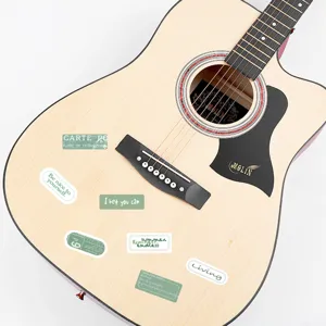 Acoustic guitar detail view featuring green motivational stickers and clear wooden texture design.