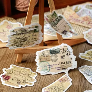 Detailed shot of vintage newspaper postmark torn stickers for DIY journal craft decor.