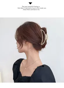 Elegant gold metal hair claw clip with half-moon design for stylish daily hair styling.