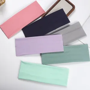 Closeup view of multiple colorful ribbed sports headbands showing elastic knit texture details.
