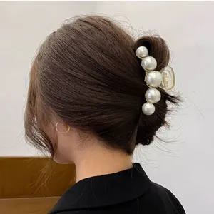 Elegant pearl hair claw clip for women, large metal matte gold hair catch for thick hair styling.